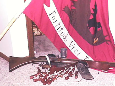 Our little collection of fun, working, 17th century reenactors things. The flag I made for Eric, his bandolier of charges-for the matchlock musket-my leather latchet shoes, a pewter goblet, and my matchlock musket.
